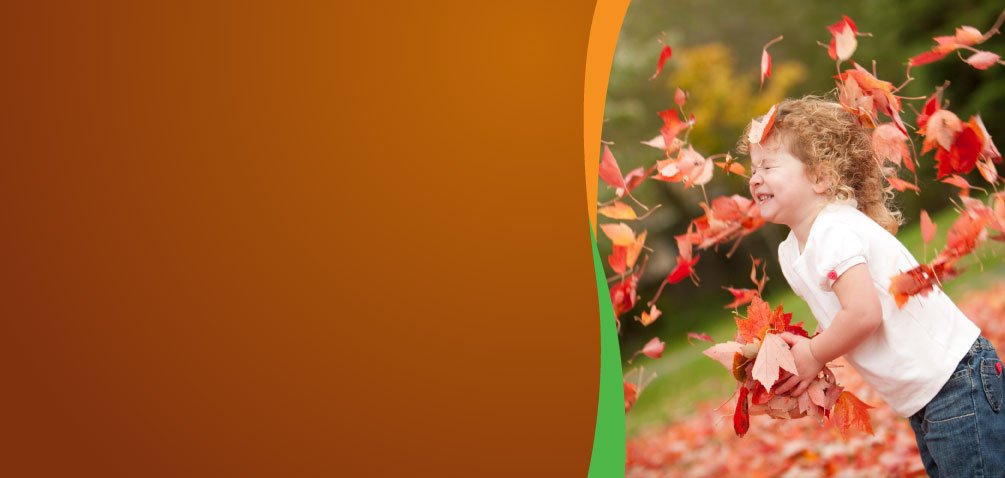 Young child with fall leaves